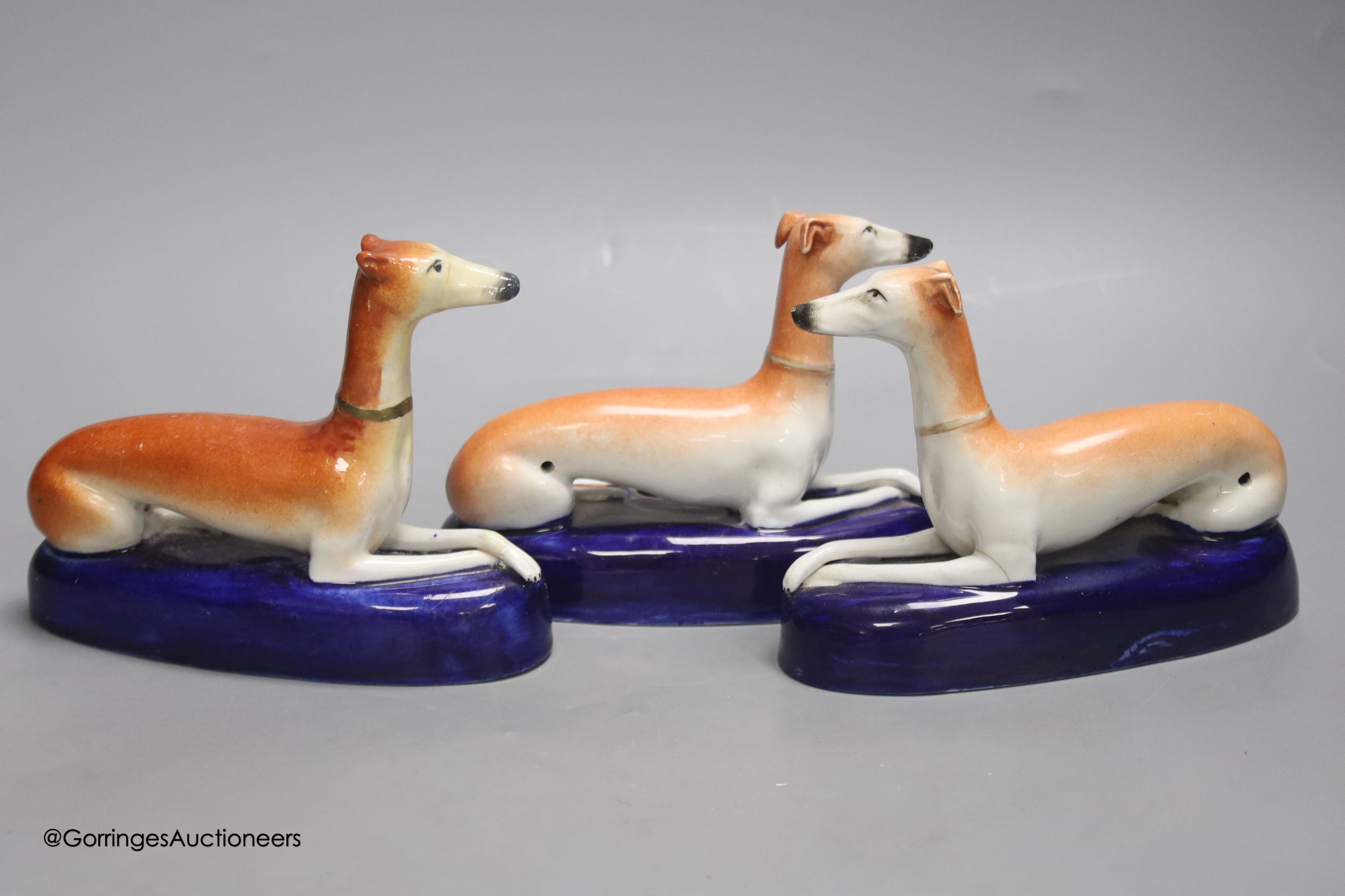 A pair of Staffordshire greyhounds and another similar, tallest 12cm